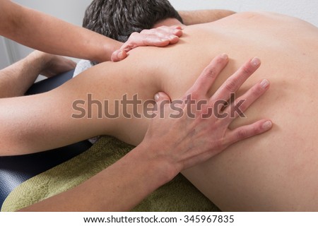 Close-up of person receiving Shiatsu Treatment from a therapist Royalty-Free Stock Photo #345967835