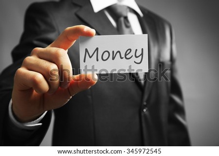 Handsome businessman holding business card close up