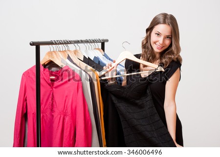 Portrait of a gorgeous young brunette woman shopping clothes.