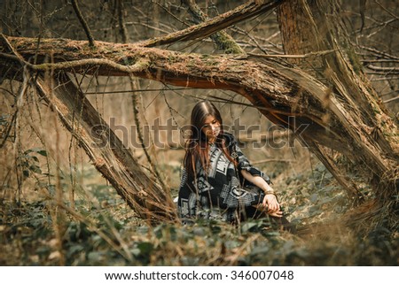 stylish beautiful  brunette girl in ethnic clothes in the amazing woods