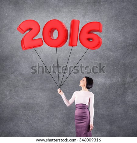 Girl with 2016 date in the form of balloons