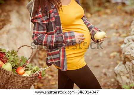 Pregnant woman outdoor. Portrait of a pregnant woman in autumn park