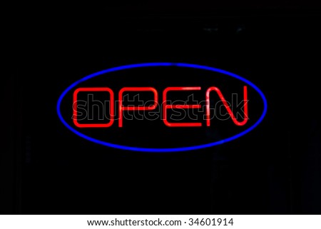 A neon OPEN sign isolated over black.