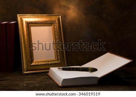 still life of picture frame on table with diary book.