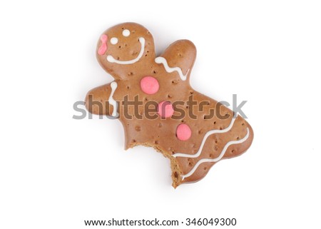 Eaten Gingerbread lady decorated colored icing. Holiday cookie in shape of  lady isolated in white background