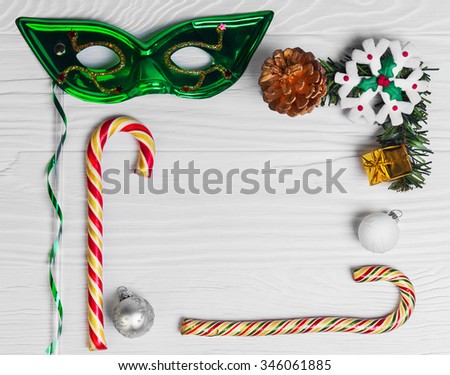 On a white background wooden table Christmas composition color branch fir tree, gift, candy cane, Christmas balls, snowflake marzipan in the middle of an empty space for your text or image