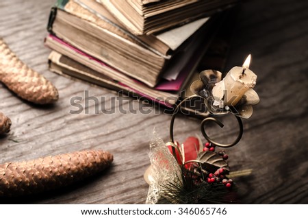 Old stacked book and candle,horizontal photo