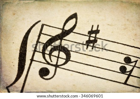 treble clef - macro of sheet music on vintage paper with added grunge texture and border Royalty-Free Stock Photo #346069601