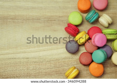 colorful macaroons on wooden background , top view