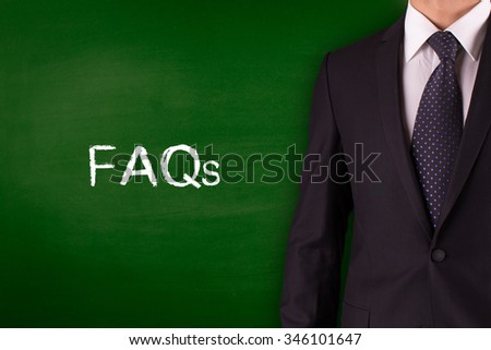 FAQ'S on blackboard with businessman