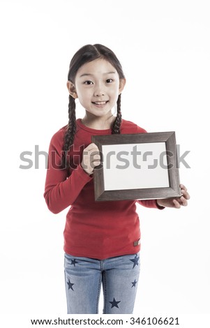 A asian(korean, japanese, chinese) girl(kid, student, child, woman, female) wearing red shirts and denim pants stand up with a wood photo frame for friend and family isolated white.