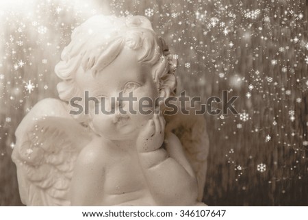 Little white angel on a silver  background.