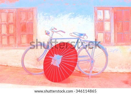a graphic color of an old fashioned bicycle and vintage northern Thai umbrella in an old background