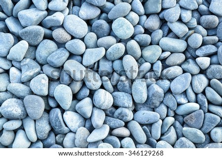 Small naturally polished blue rock pebbles background