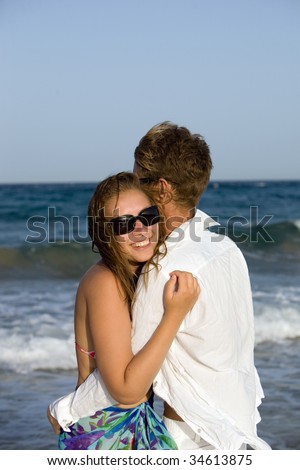 Beautiful young couple enjoying on beach