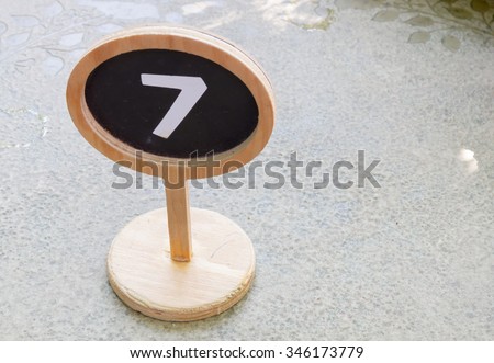 closeup number 7 on wooden sign board