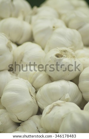 Garlic clove vegetables on sale in supermarket grocers shop on display.