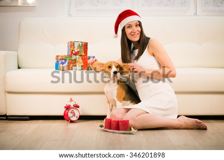 happy smiling girl in santa hat with her dog