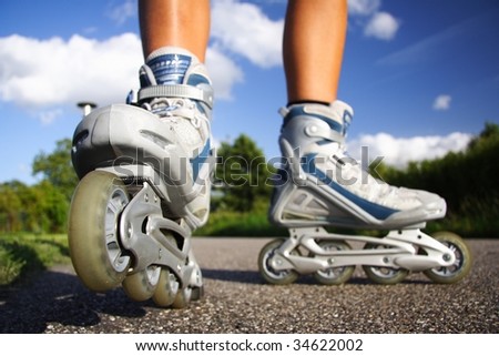 Rollerblades  inline skates closeup in action outdoors on sunny day.