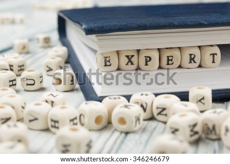 Expert word written on wood block