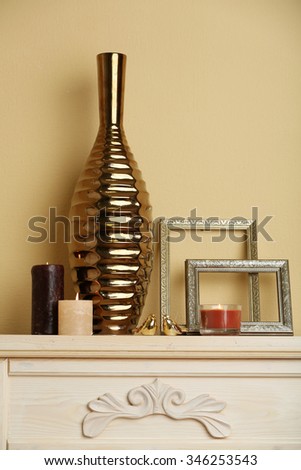 Modern vase with decor on fireplace in room