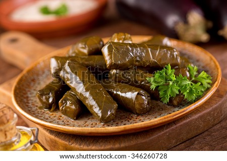 A plate of delicious stuffed grape leaves with parsley garnish. Royalty-Free Stock Photo #346260728