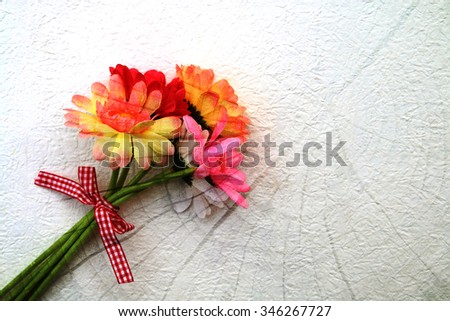 bunch of artificial flower screen on surface of tree cut