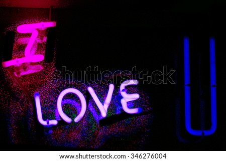 I love you neon sign at night in street photo.