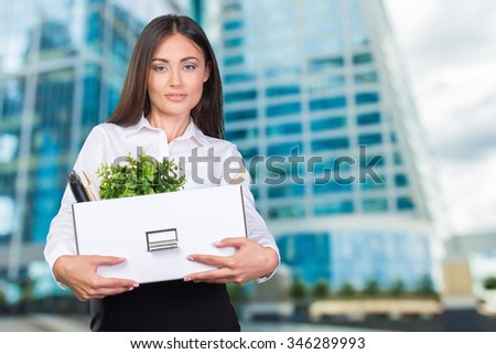Young happy business woman with a box to move to a new office. 