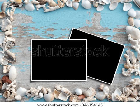 Picture frames and sea shells on grunge wood ,top view
