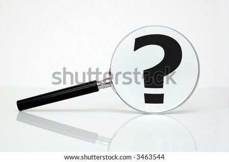 Magnifying glass and question mark - conceptual photo.