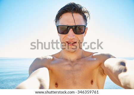 young  man make selfie on the beach. 