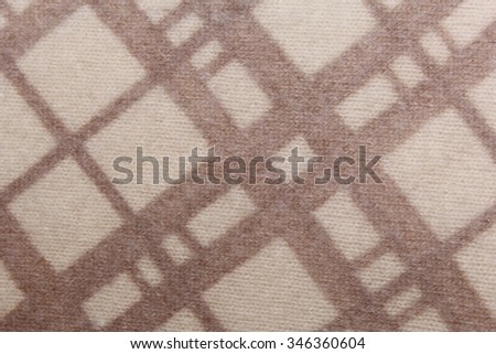 Texture. Knitted fabric checked brown-beige color.