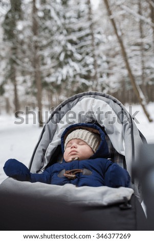 Portrait of sleeping baby in winter park