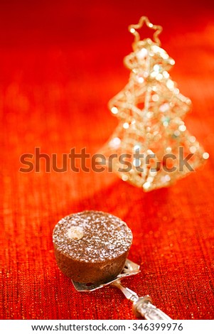 Chocolate  Mini Tartlets in vintage spoon with festive golden red style, shallow dof