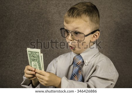 Boy examines dollars