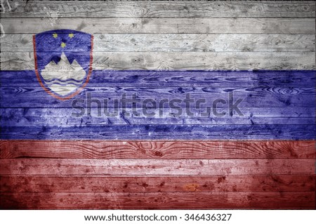 A vignetted background image of the flag of Slovenia onto wooden boards of a wall or floor.