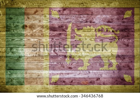A vignetted background image of the flag of Sri Lanka onto wooden boards of a wall or floor.