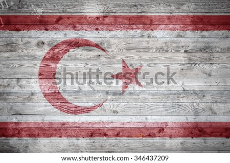 A vignetted background image of the flag of Northern Cyprus onto wooden boards of a wall or floor.