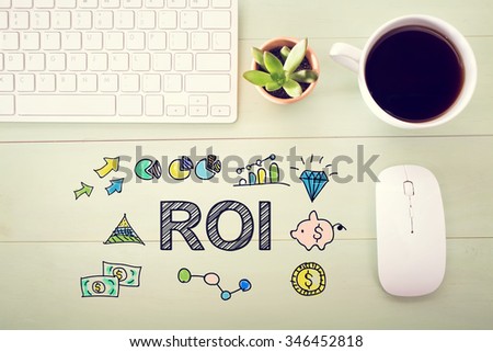  ROI concept with workstation on a light green wooden desk