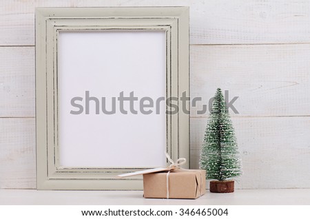 Christmas and New Year background. Empty picture frame, fir and vintage gift box with with copy space blank tag on white background. Copy space image. Scandinavian style home interior decoration