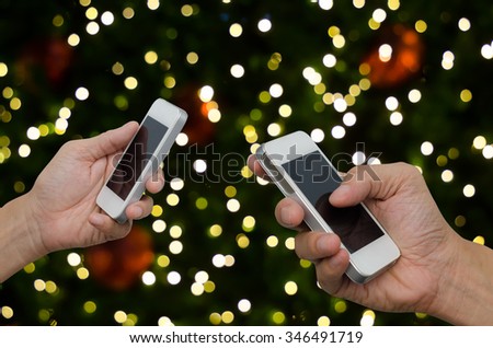 Hands using mobile smart phone at christmas party, communication concept.