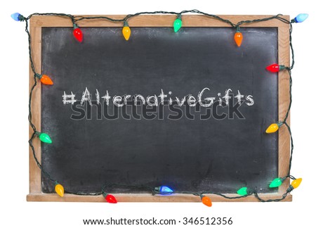 Alternative Gifts written in white chalk on a black chalkboard surrounded with colorful lights isolated on white
