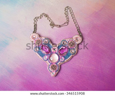 women hand made jewelery on pink background