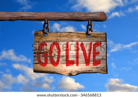 Go live motivational phrase sign on old wood with blurred background