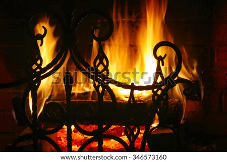 close-up fragment of forged grate on a background of flames 