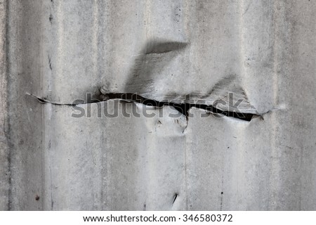 Cut in corrugated metal sheet close-up Royalty-Free Stock Photo #346580372