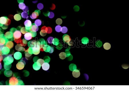 The blurred bokeh background of colorful lights from the party