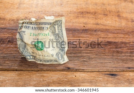 Old one American dollar put on wooden desk