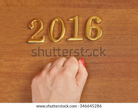 Hand and numbers 2016 on door - new year concept background